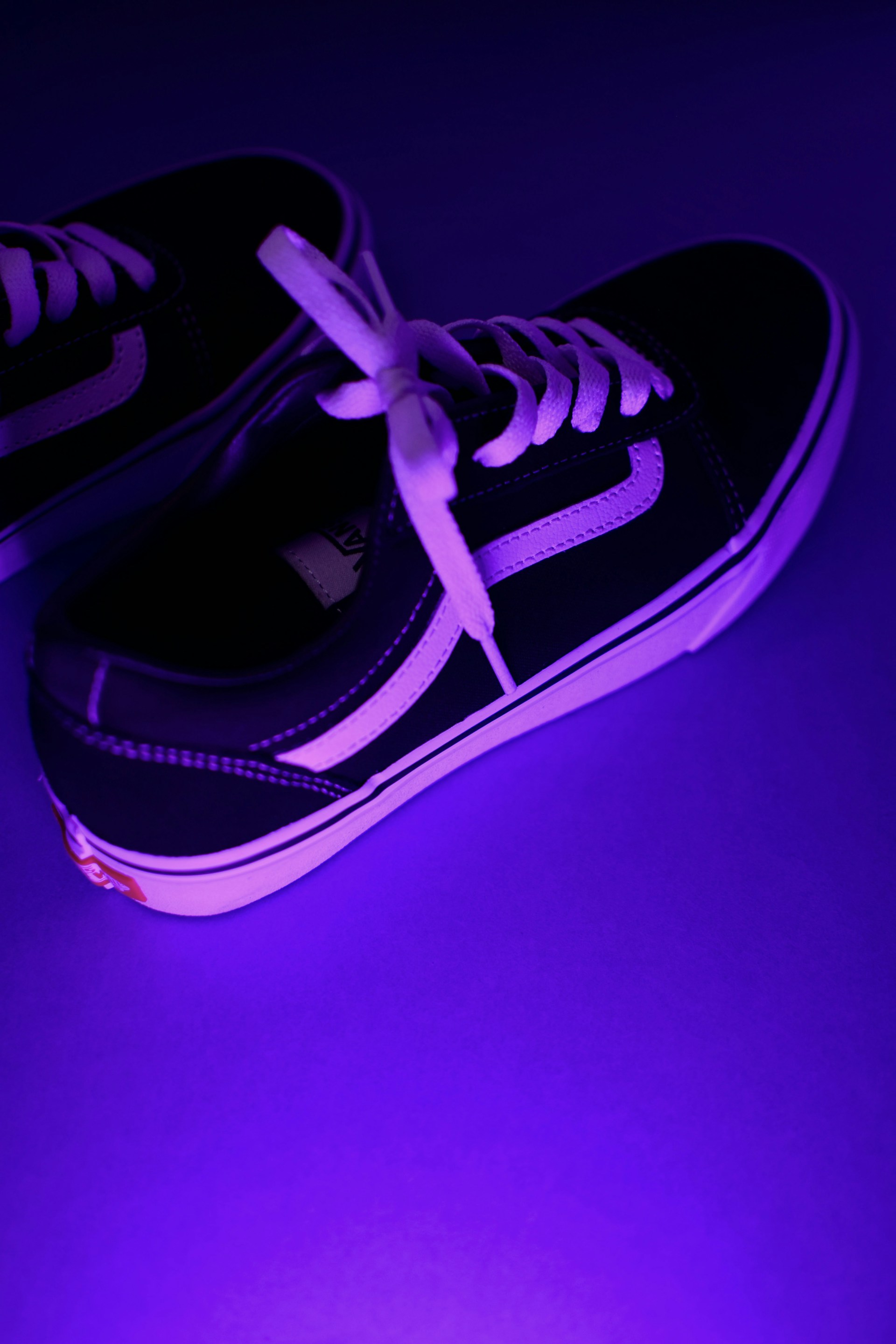 a purple shoe with a black lace