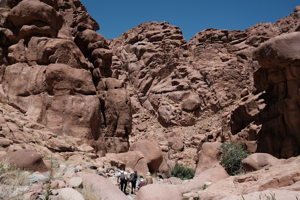 people walking on a rocky terrain