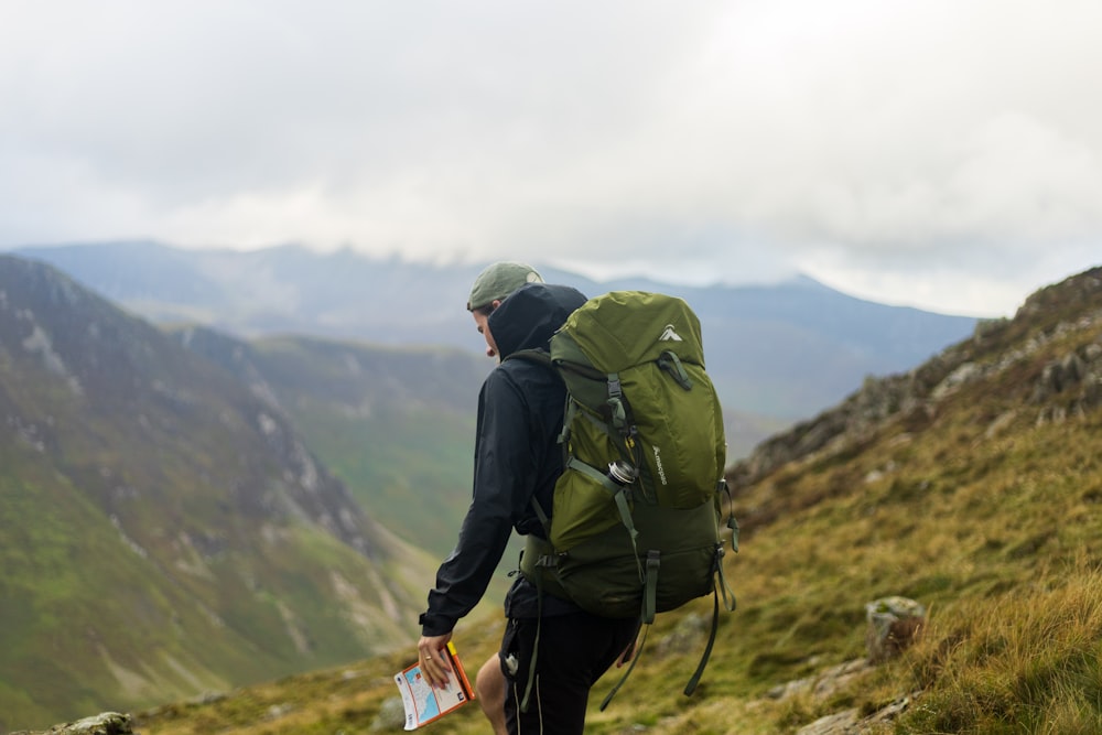 a man with a backpack on a mountain