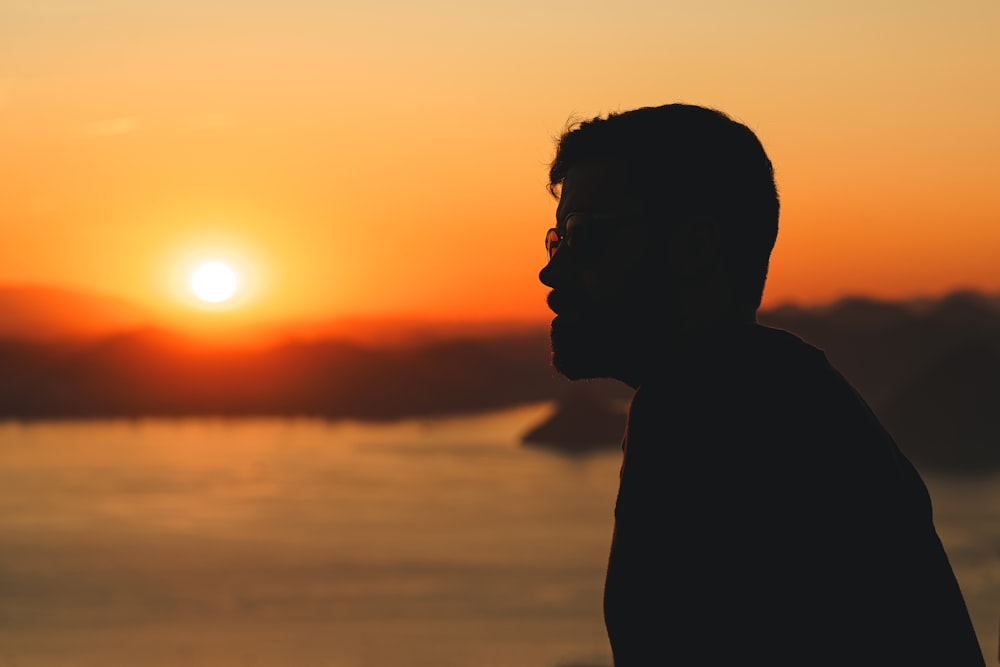 a man looking at the sunset