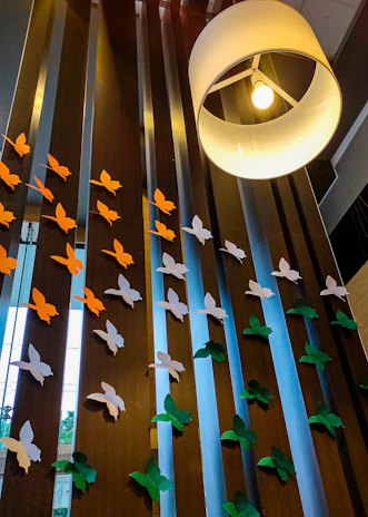 A cozy living room wall adorned with several 4x4 butterfly prints in sleek black frames.