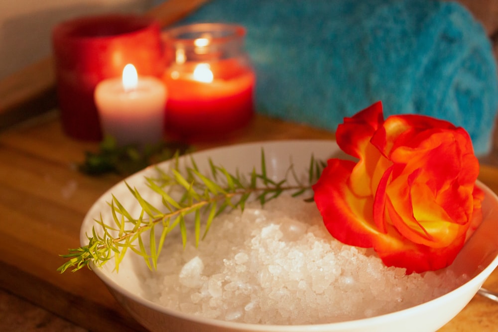 a plate of food with candles in the background