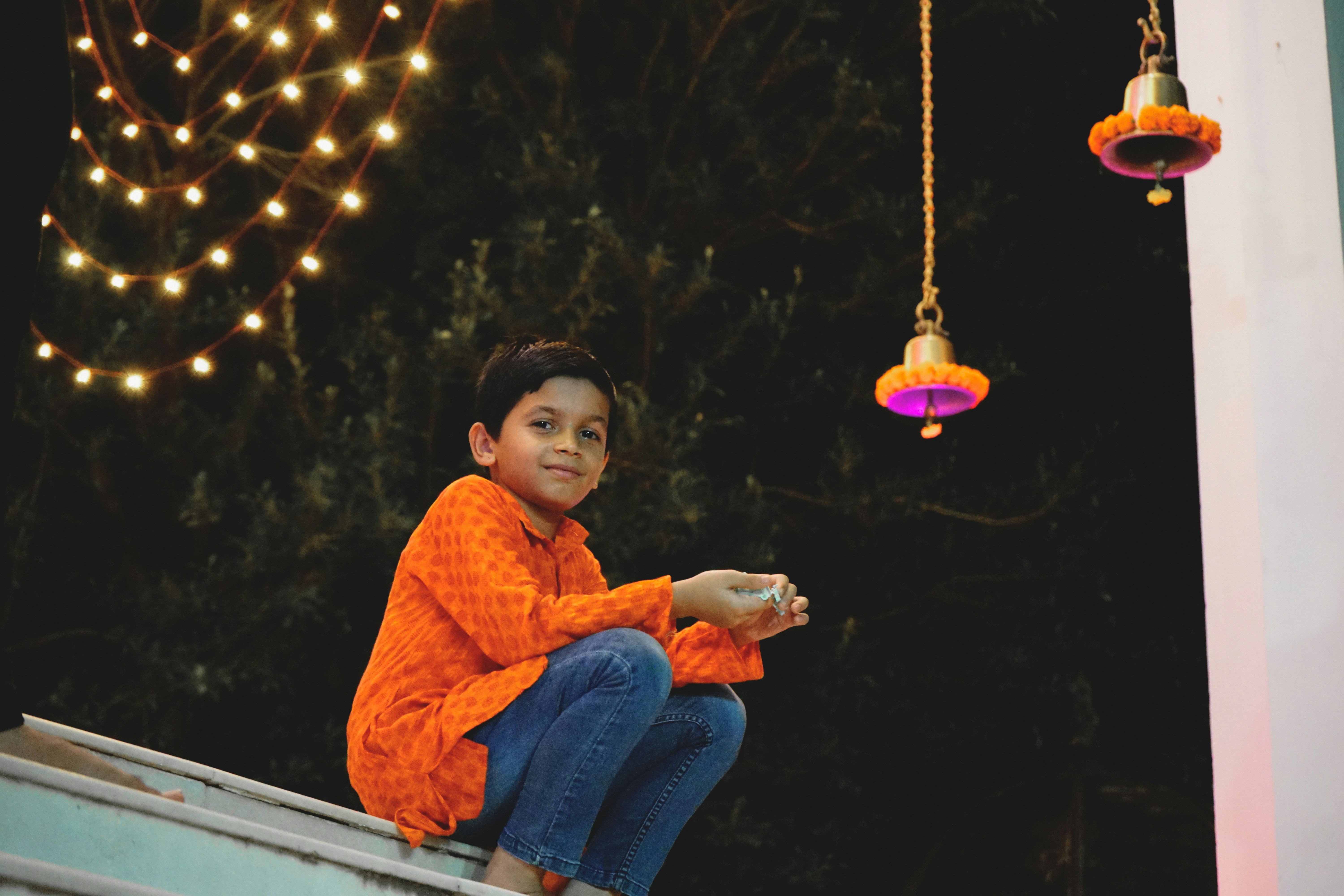 a boy sitting on a ledge