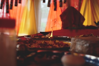 A traditional kundli chart illuminated softly on a wooden table with a small oil lamp.