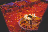 Festive gift hamper featuring handmade pooja items and scented candles wrapped in ivory and gold.