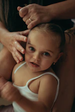 Therapist gently working with a child using craniosacral therapy techniques.