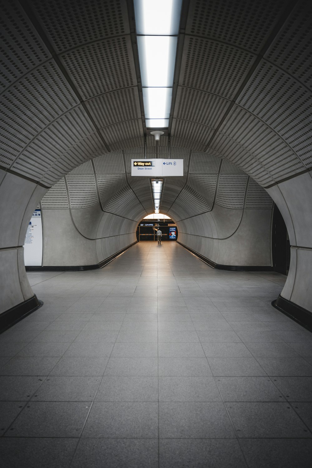 a person walking down a tunnel