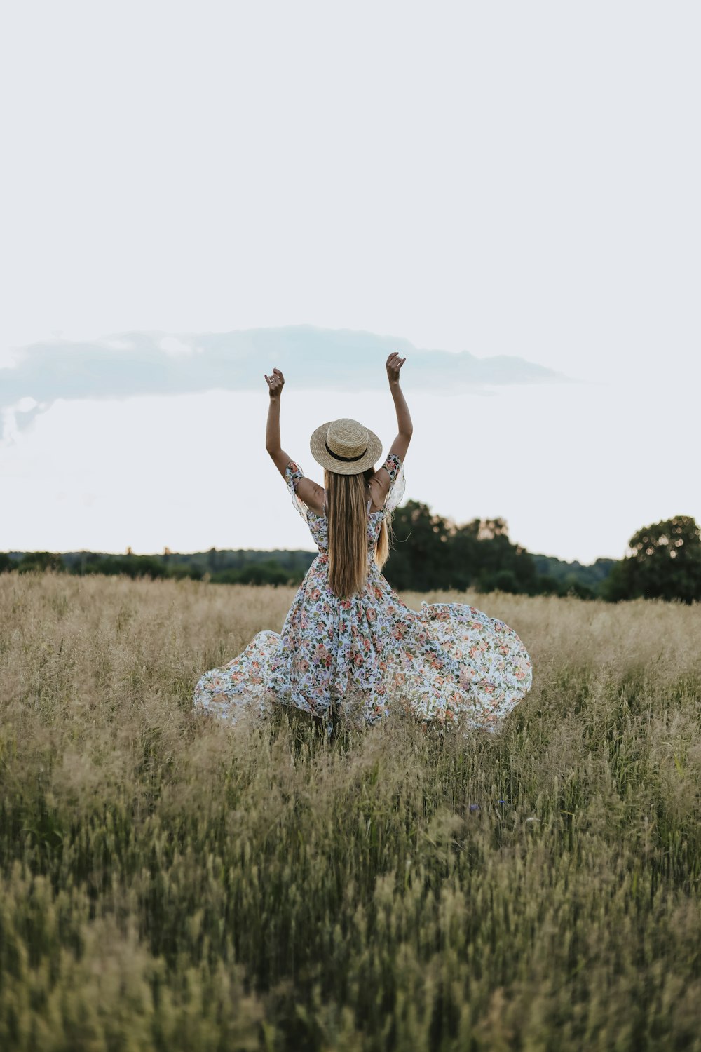 a person in a dress and hat in a field