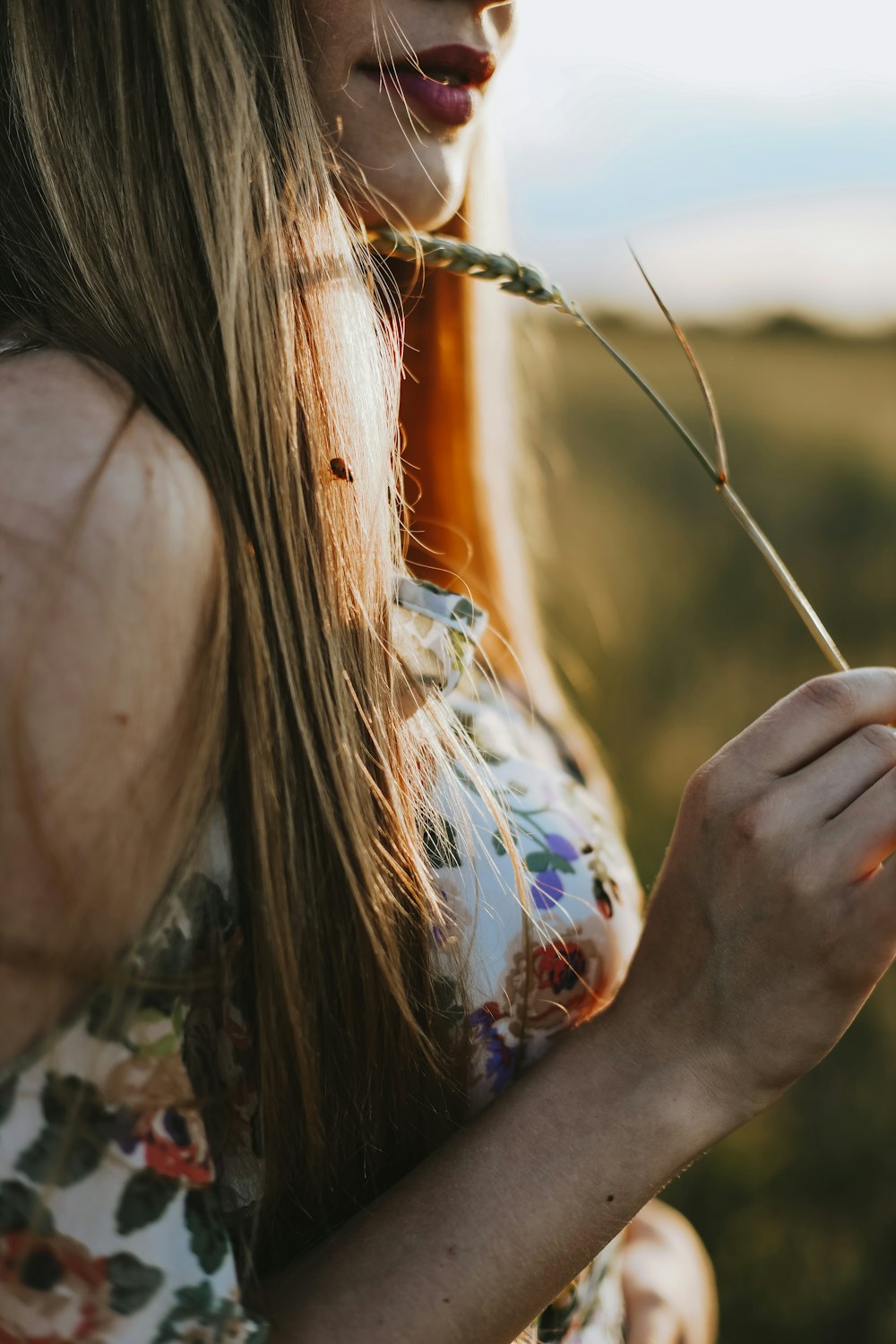 a woman holding a string of colorful string