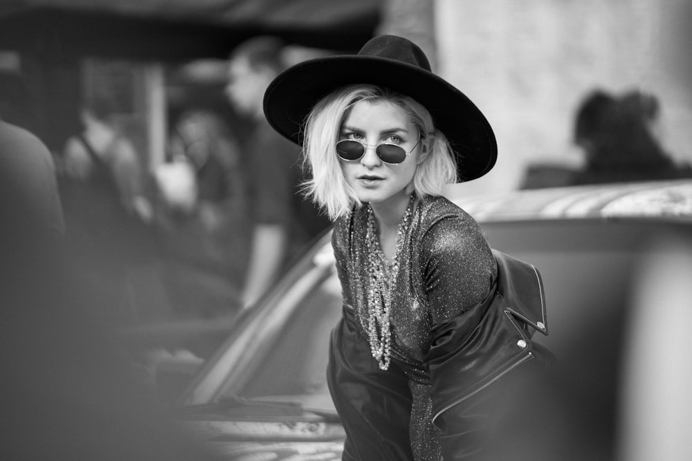 a woman wearing a hat and sunglasses