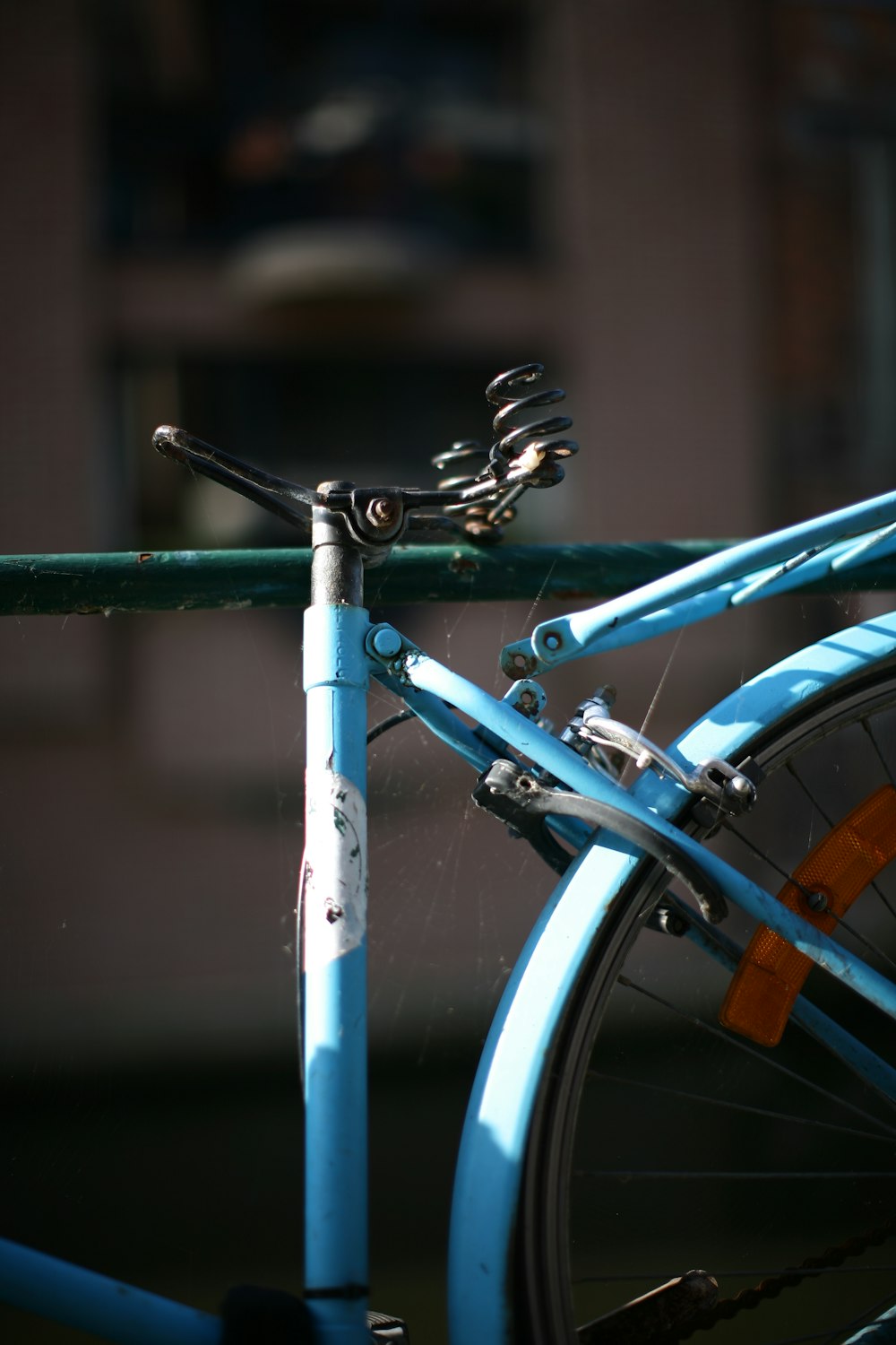 a blue bicycle with a green handlebar