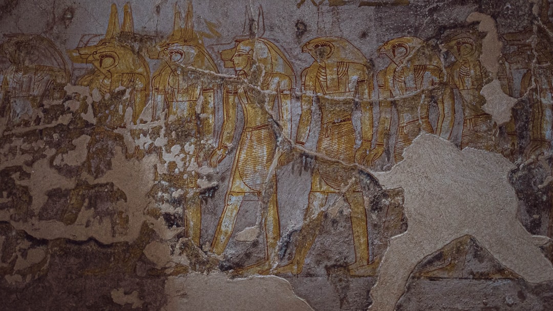 ancient carvings on a wall, Worn hieroglyphics have been restored without hiding the damage that has occurred over time.