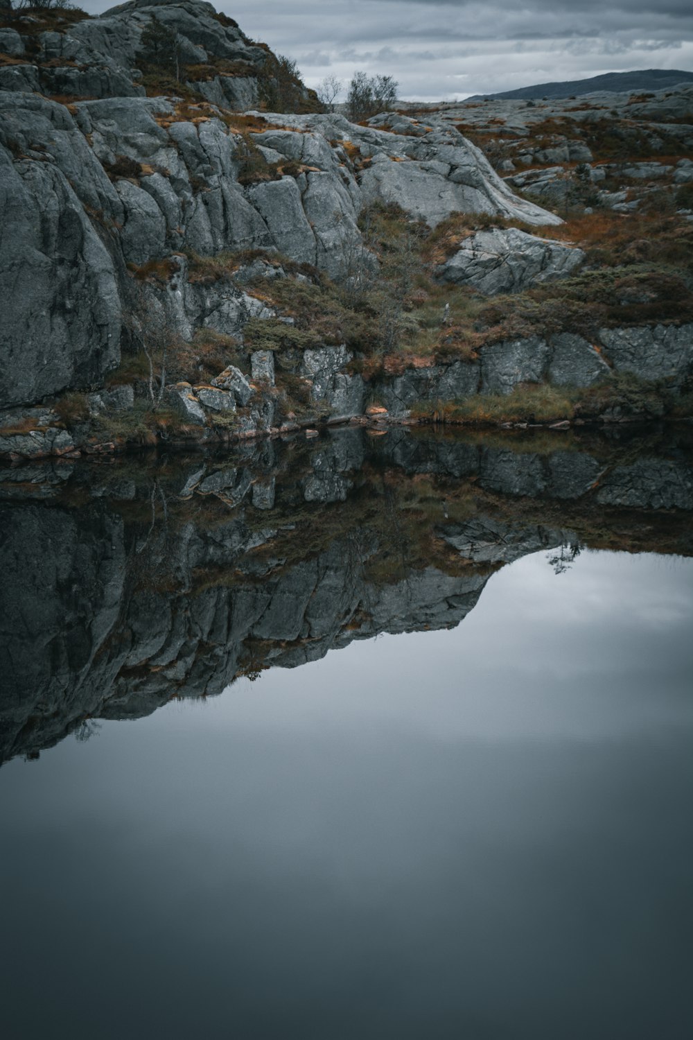 una scogliera rocciosa con uno specchio d'acqua sottostante