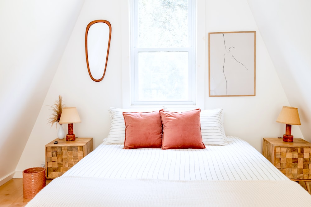 a bed with red pillows