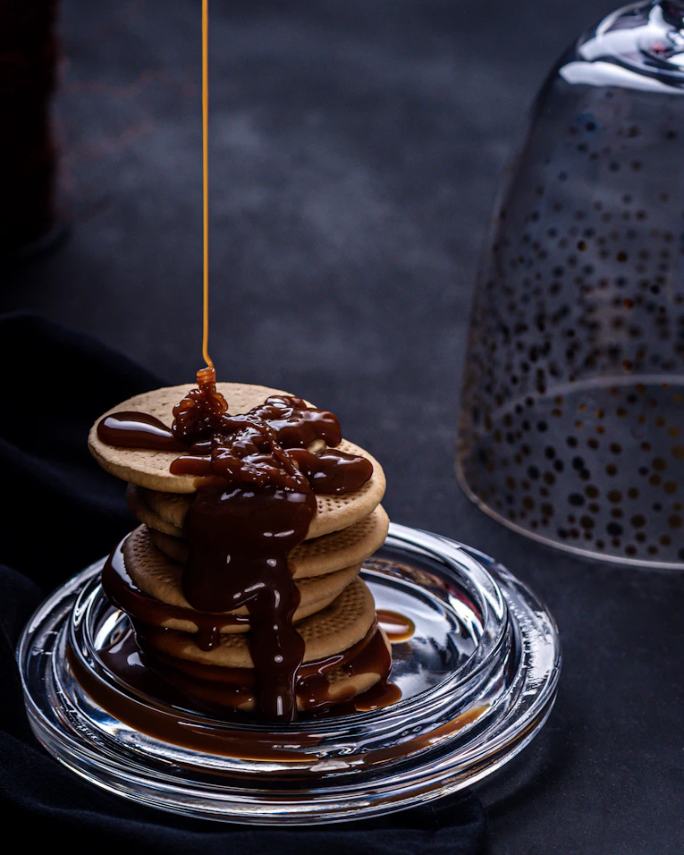 Mini pancakes smothered in chocolate sauce