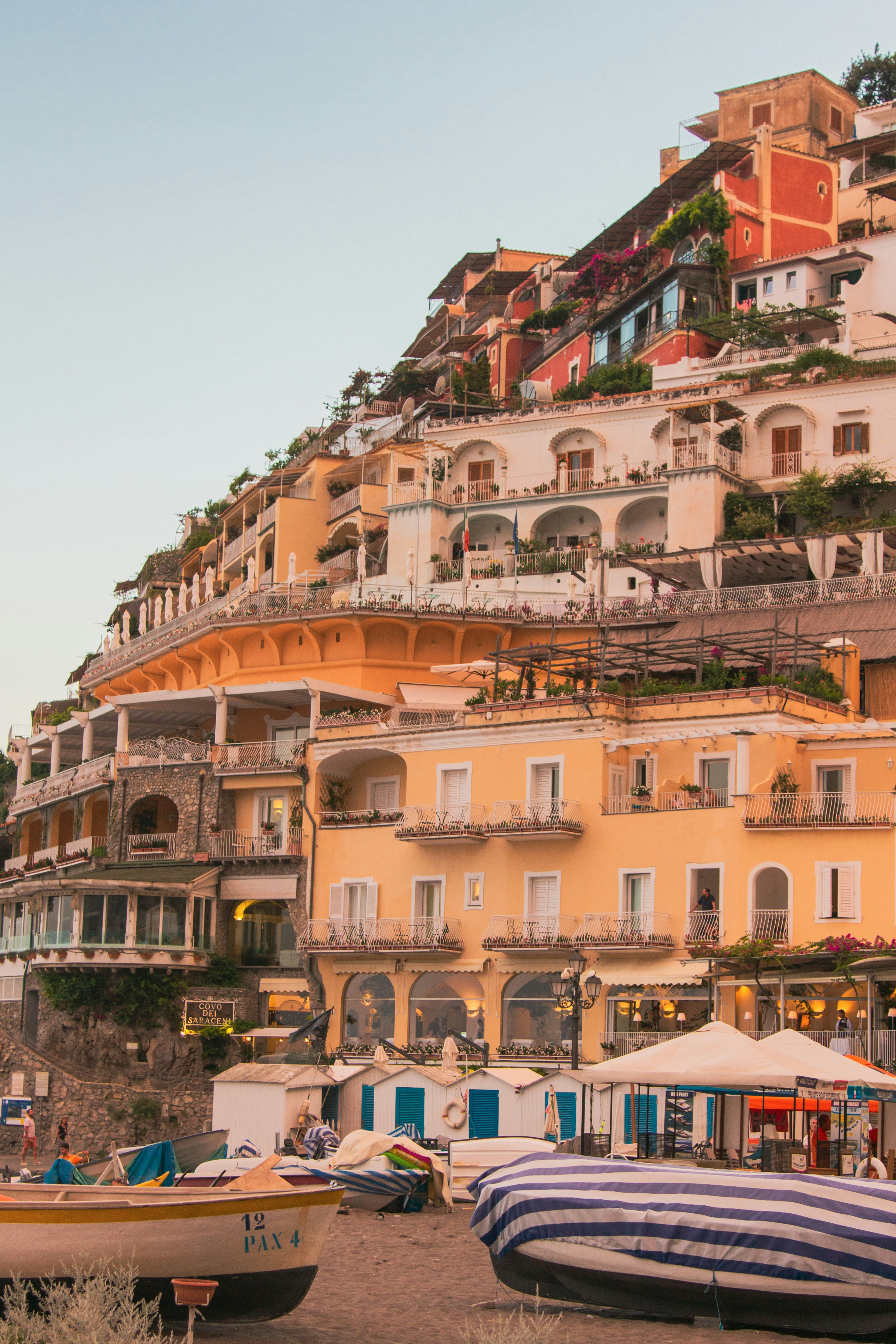 a group of buildings with a hill in the background