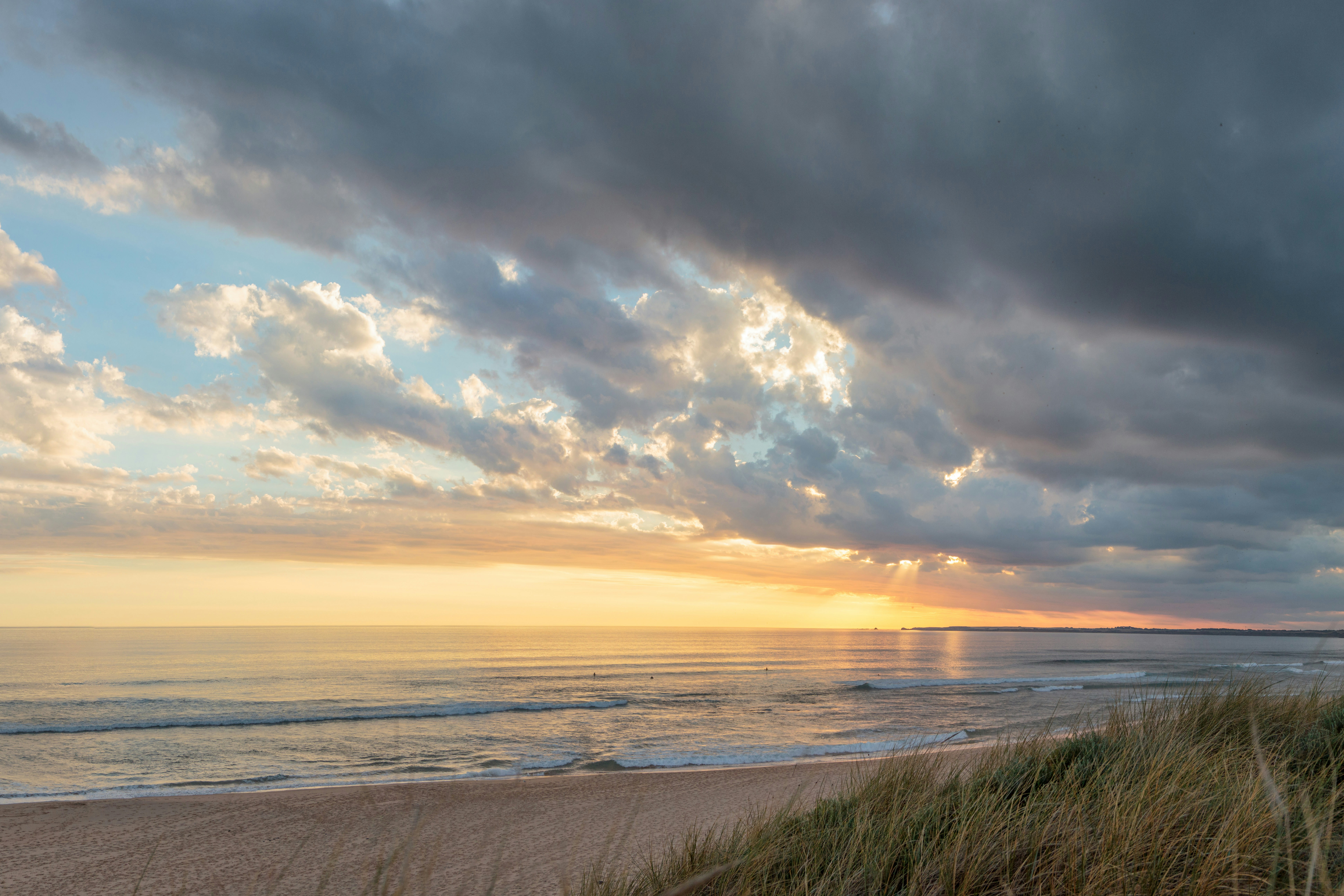 a beach with a cloudy sky