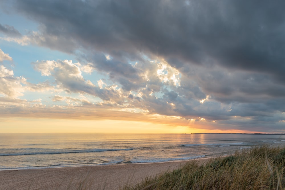 a beach with a cloudy sky