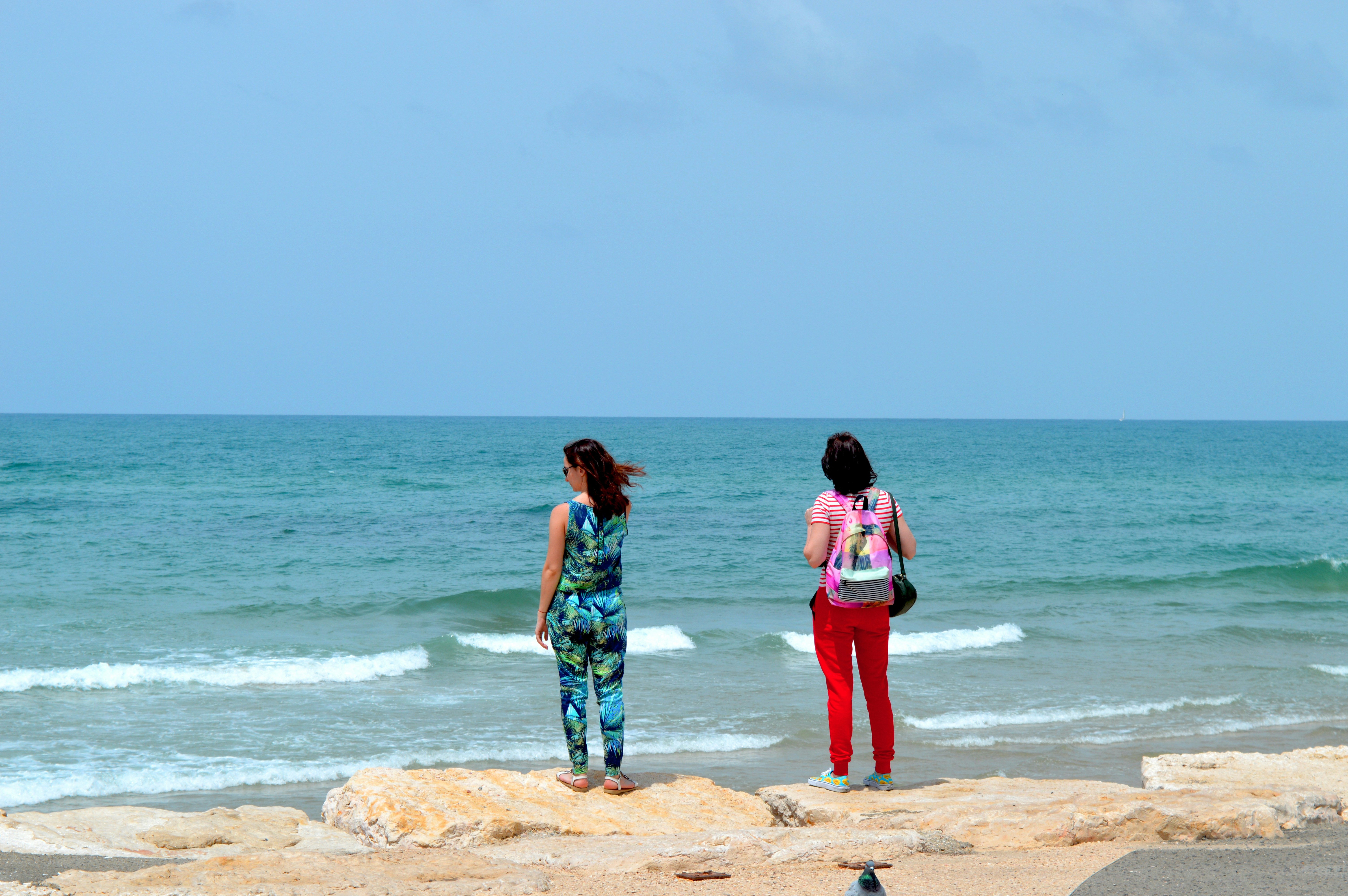 two girls standing on a beach