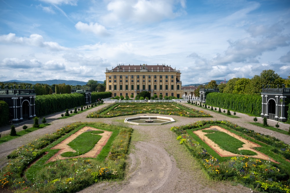 a large building with a garden in front of it