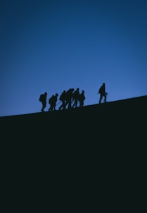 a group of people standing on a hill