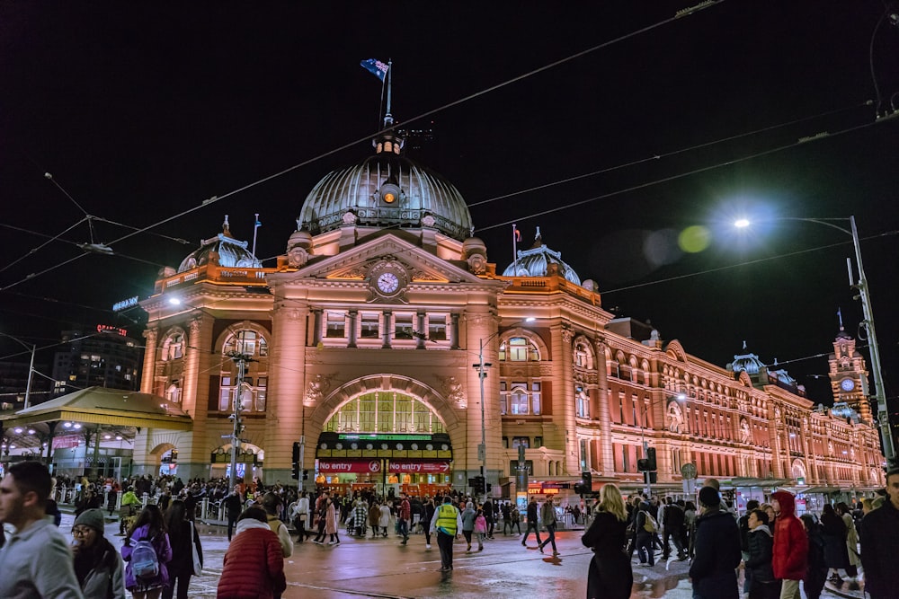 a large building with a clock tower with Flinders Street railway station in the background