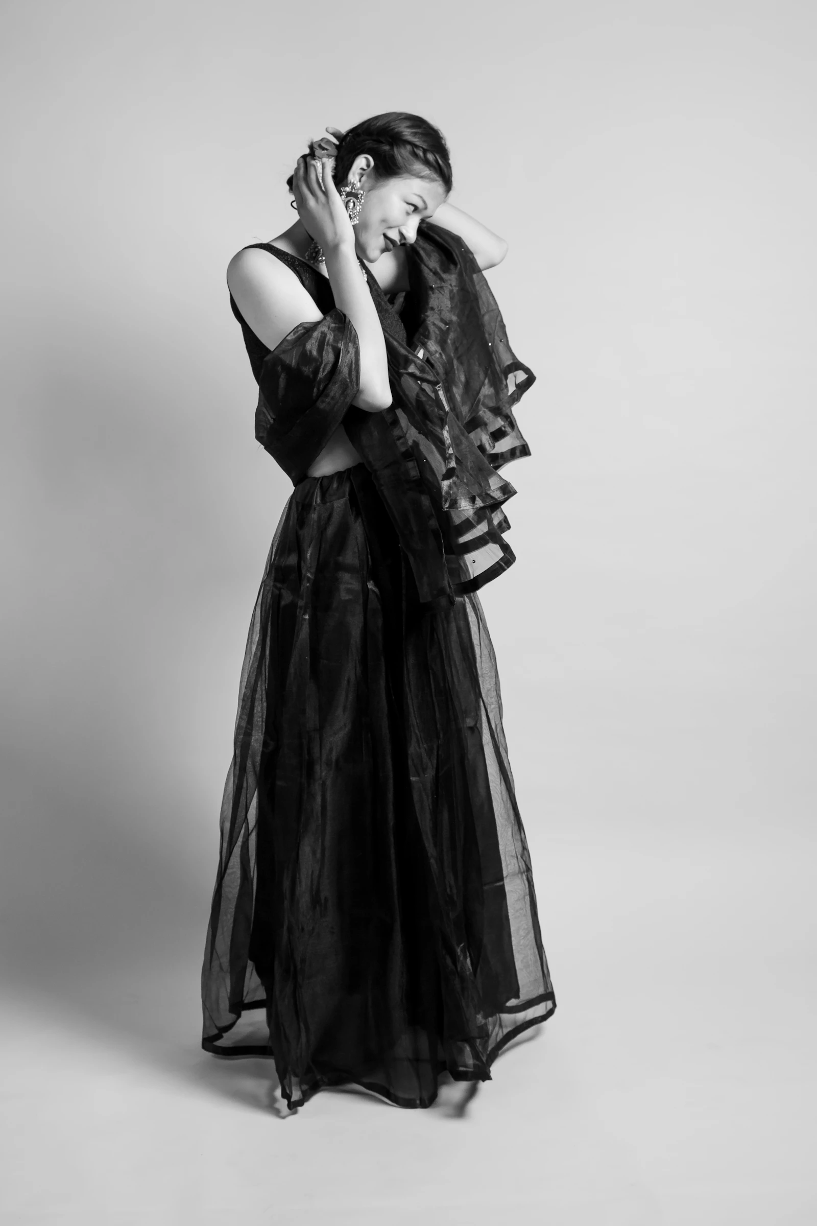 A woman in a sheer flowing maxi skirt