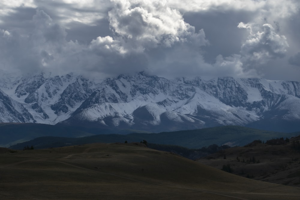 a landscape with mountains and clouds