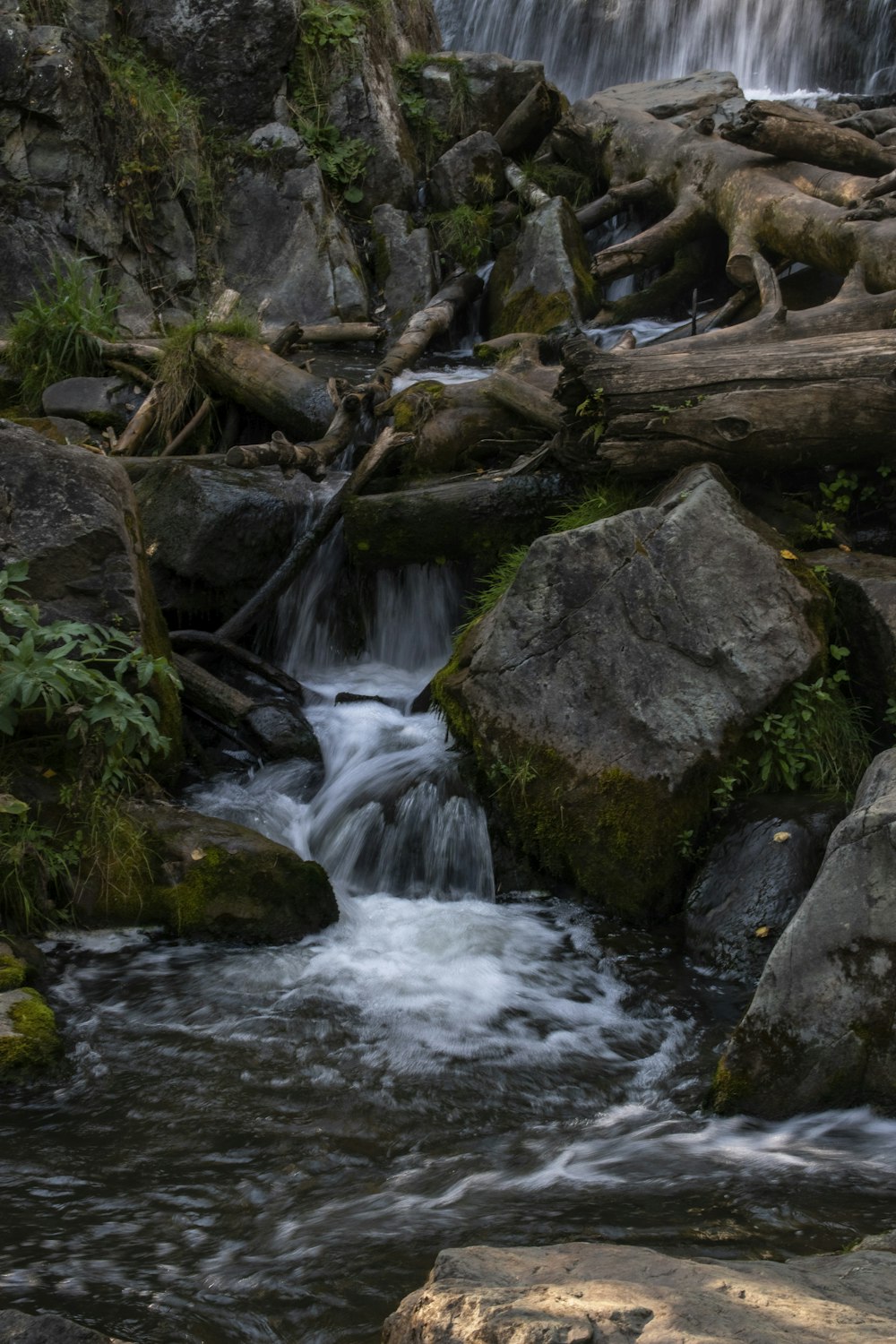 a small waterfall with rocks