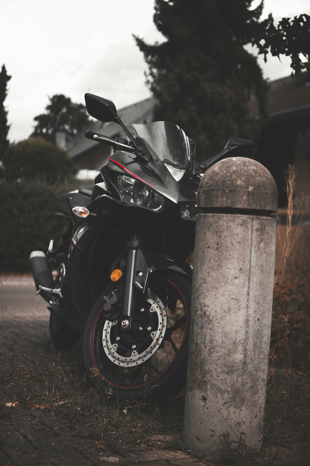 a motorcycle parked next to a post