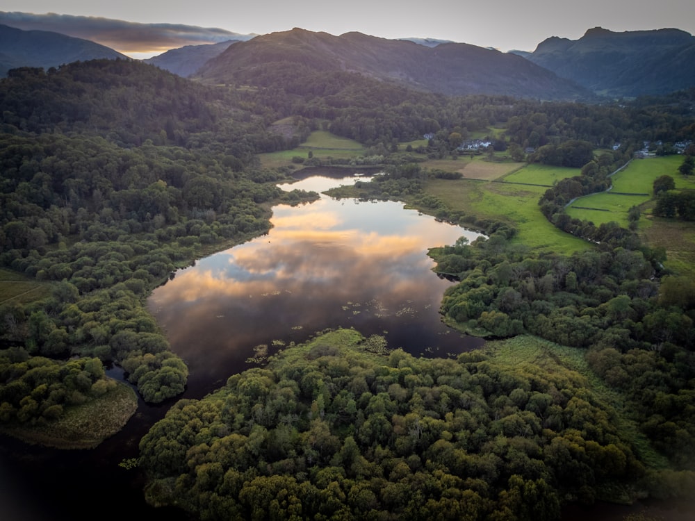 a river surrounded by trees and mountains