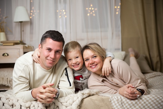 a man and woman with a couple of children on a bed