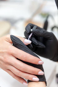 a person holding a black glove