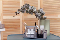 Artistic display of nail tools and rose gold accents on a sleek black surface