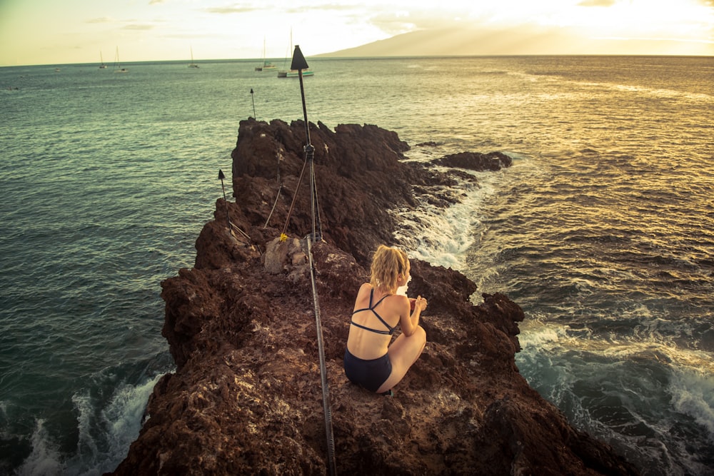 a person sitting on a rock