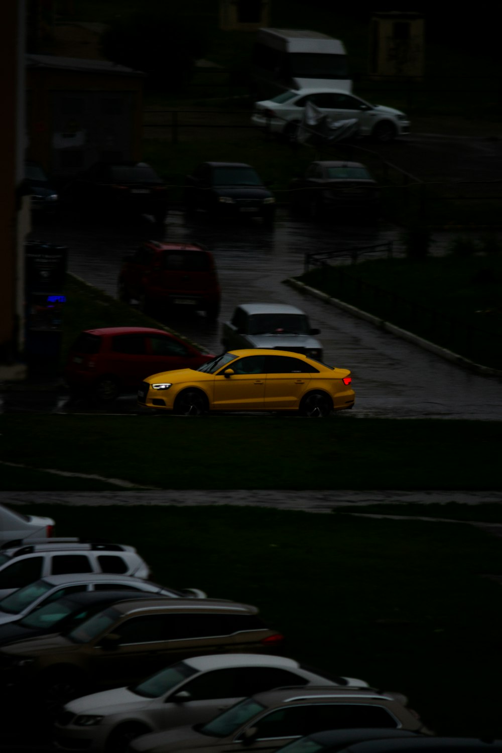 a yellow car parked in a parking lot