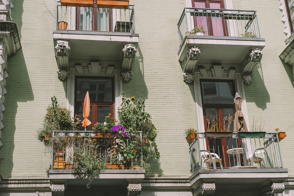 a building with balconies and plants on the balcony