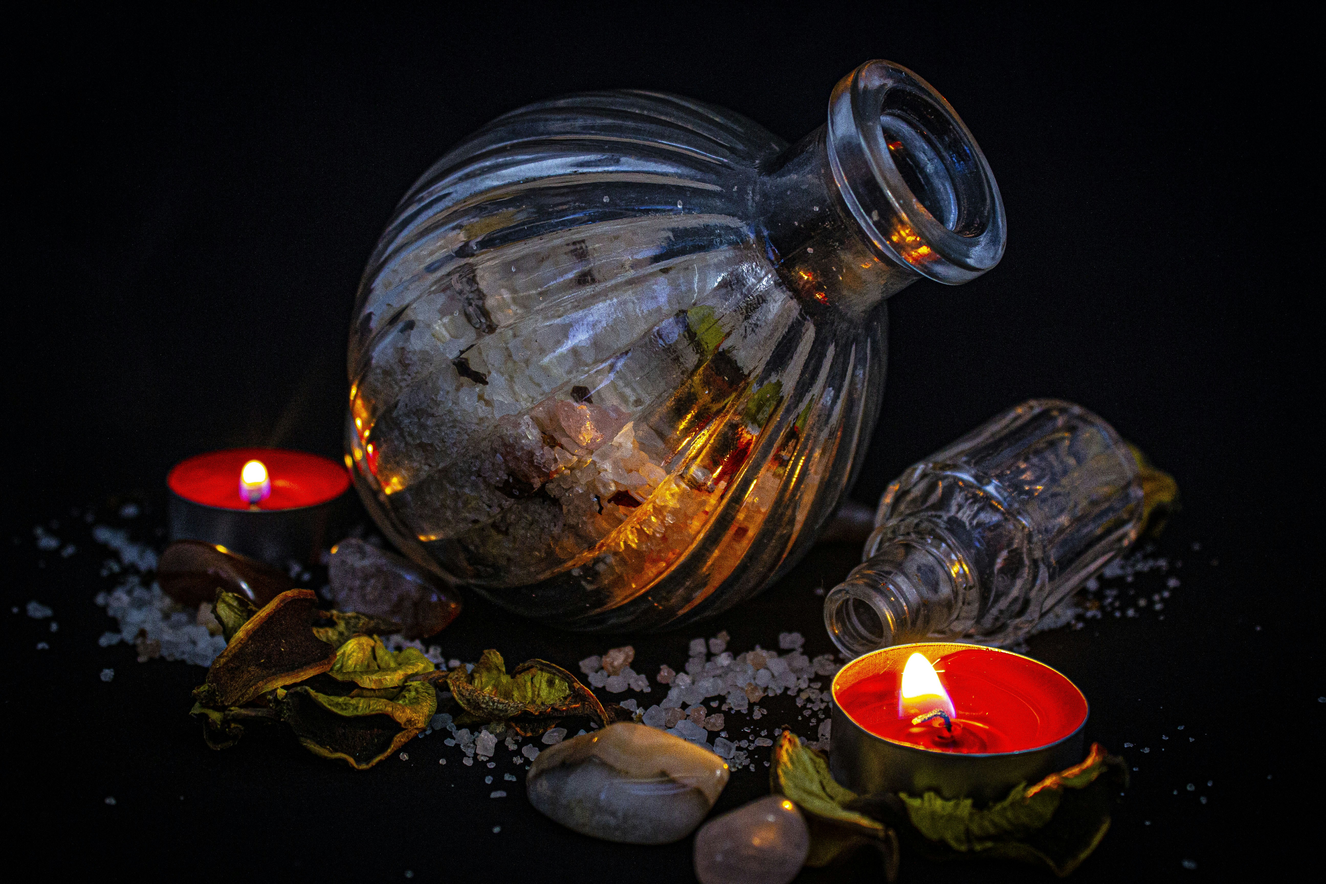 Artemis Night Elixir dark violet bottle with dried herbs on indigo velvet, mystical lighting