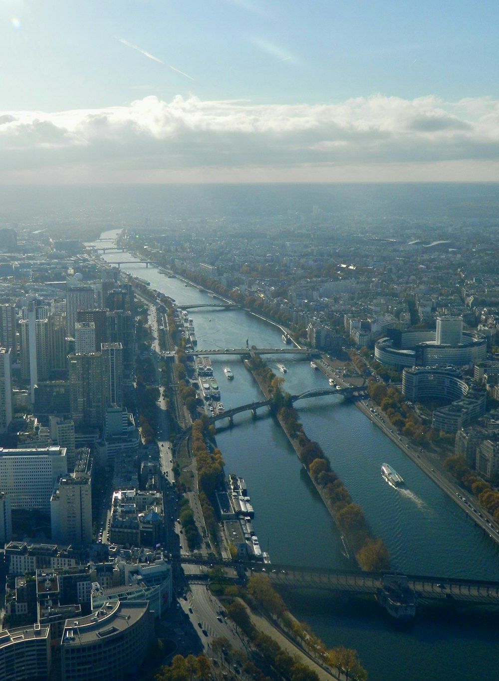 a river with a bridge and a city in the background