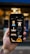 A hand holding a smartphone displaying several fashion and beauty icons. The screen shows images such as a dress, a face with a hat, a comb, a razor, and other beauty-related icons. The background appears out of focus, adding emphasis to the phone's screen.