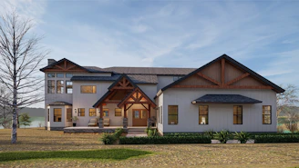 A sleek custom home with navy blue accents under a clear Texas sky.