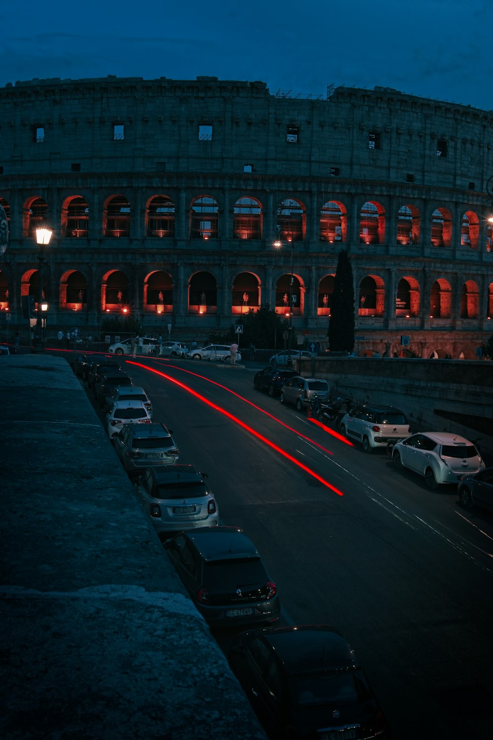 a large building with many cars parked in front of it