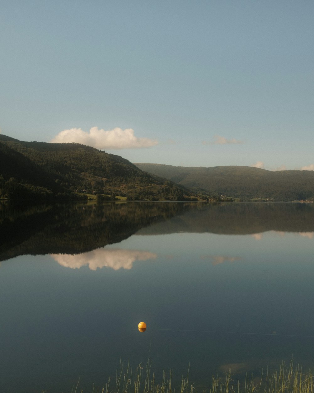 a body of water with hills in the background