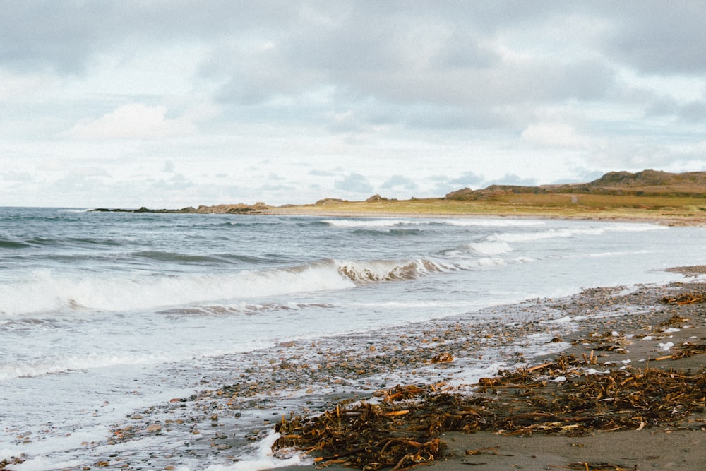 a beach with waves crashing on it