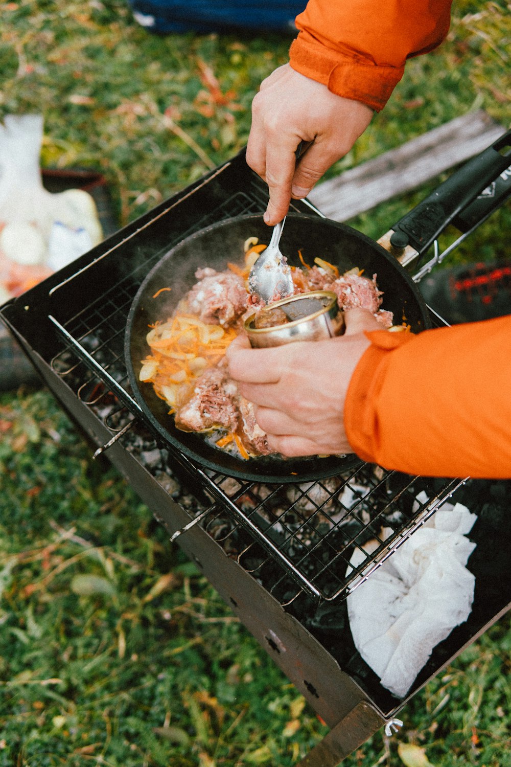a person cooking food on a grill