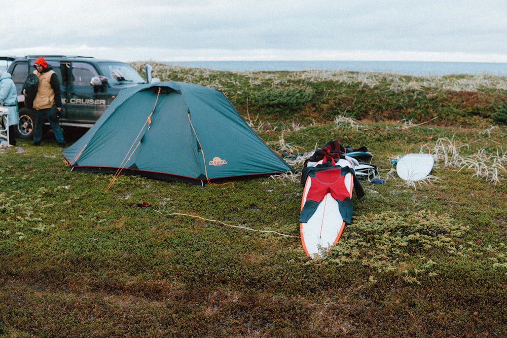 a person standing next to a tent