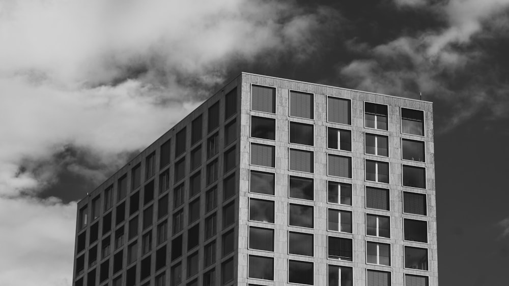 a tall building with clouds in the background