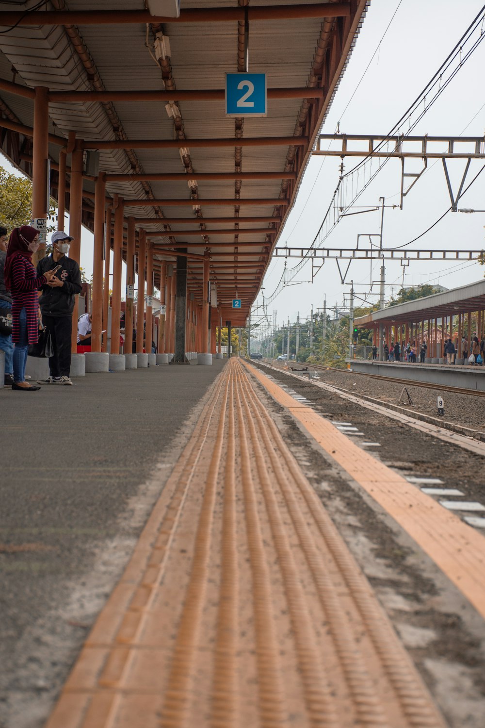 a train station with people waiting