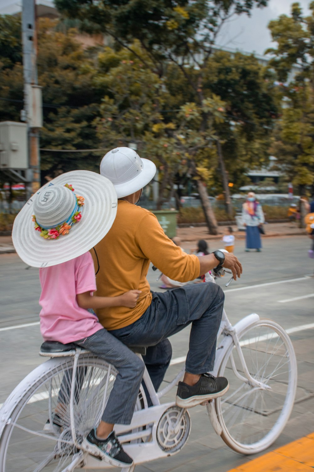 a couple of people ride on a bicycle