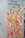 A wall is covered with numerous sticky notes in various colors such as pink, yellow, and orange. Above the notes, there is a message encouraging people to share their experiences. The sticky notes are filled with handwritten messages, some legible with phrases and doodles.